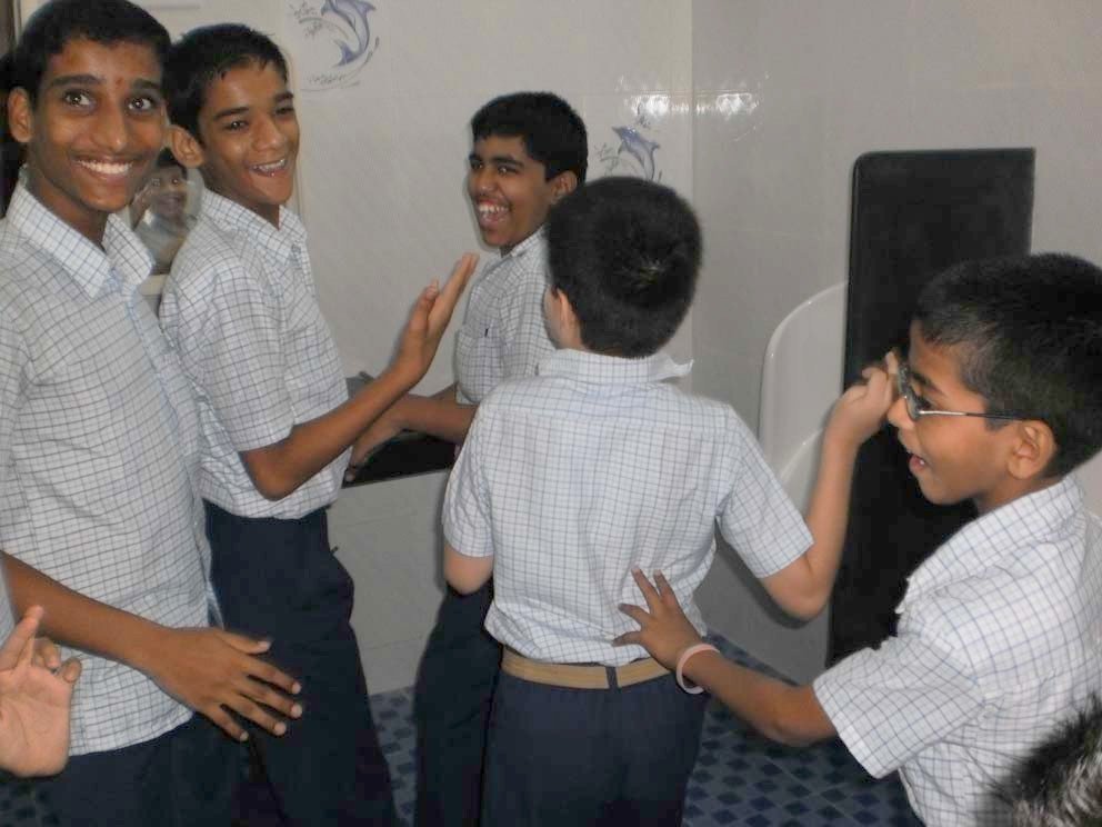 A group of boys laughing together inside the newly renovated bathroom