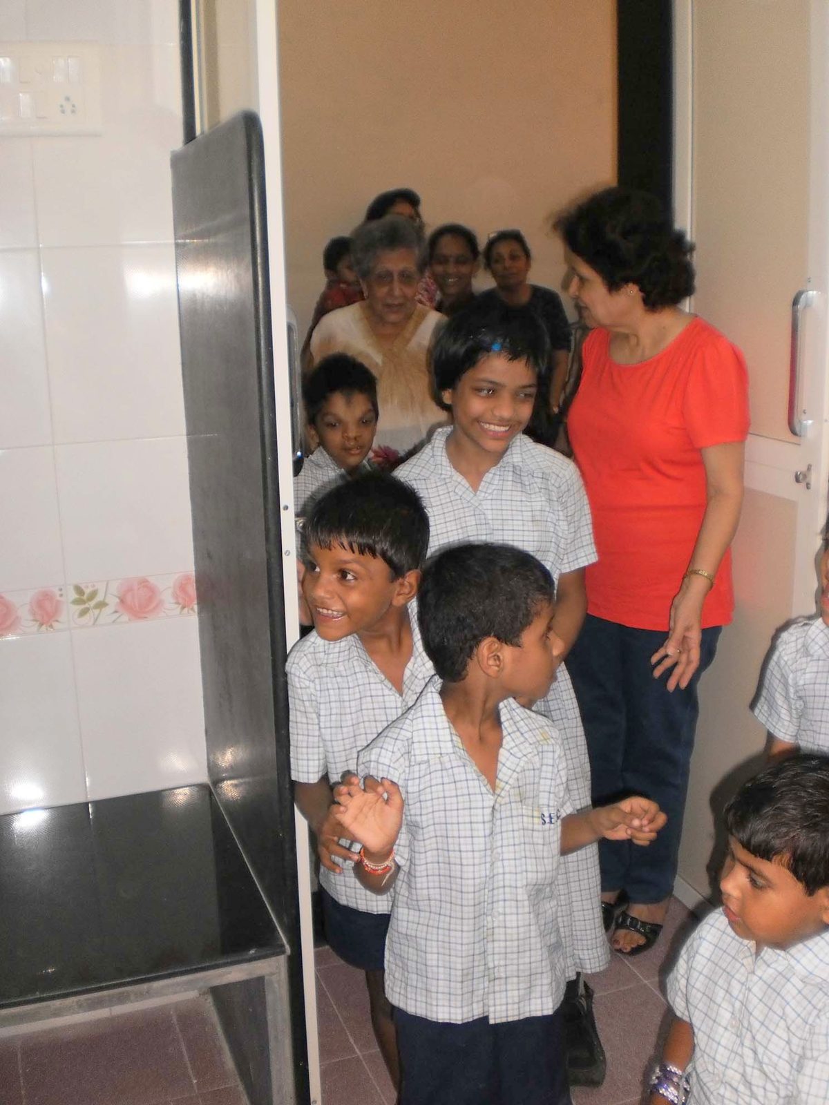 Students celebrating together at the entrance to the newly renovated bathrooms